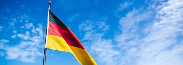 german flag with blue sky in background