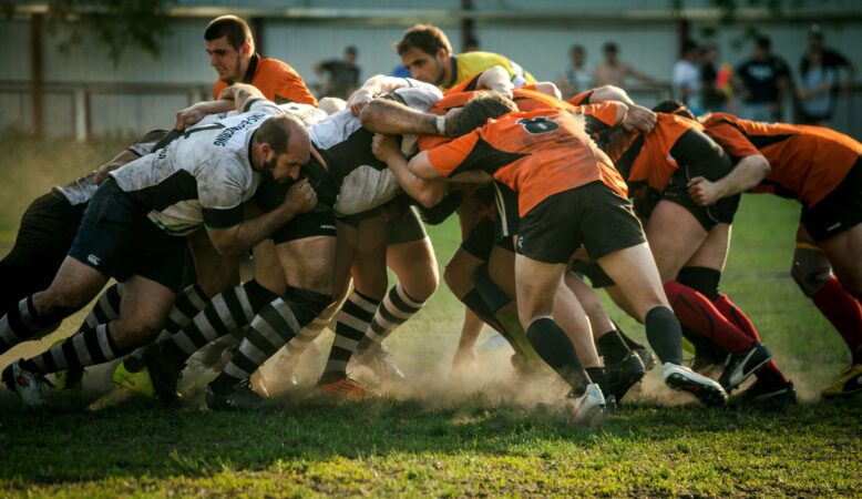 group-of-men-playing-a-rugby-game-in-the-field-clashing